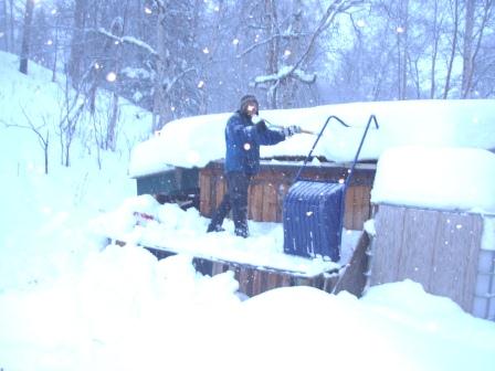 Pete shoveling off horse shed roof